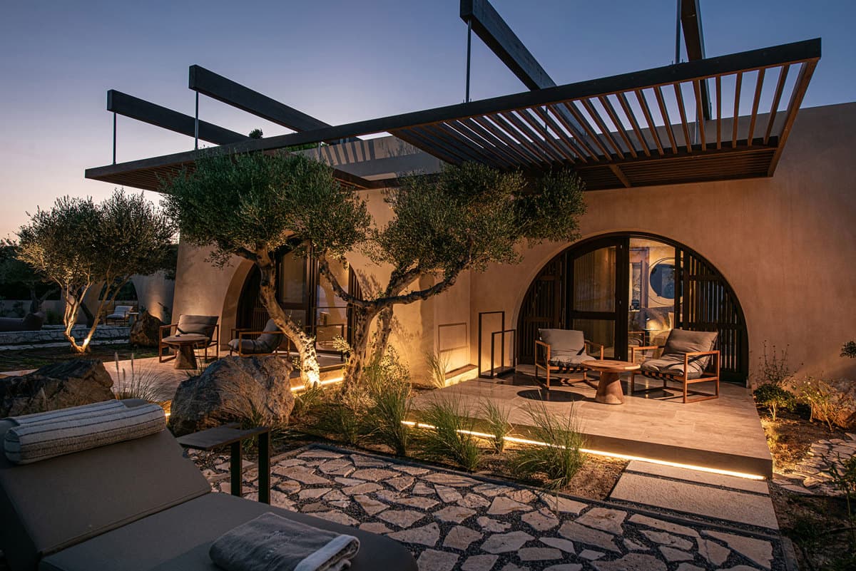 Evening view of the villa with pergolas and olive trees
