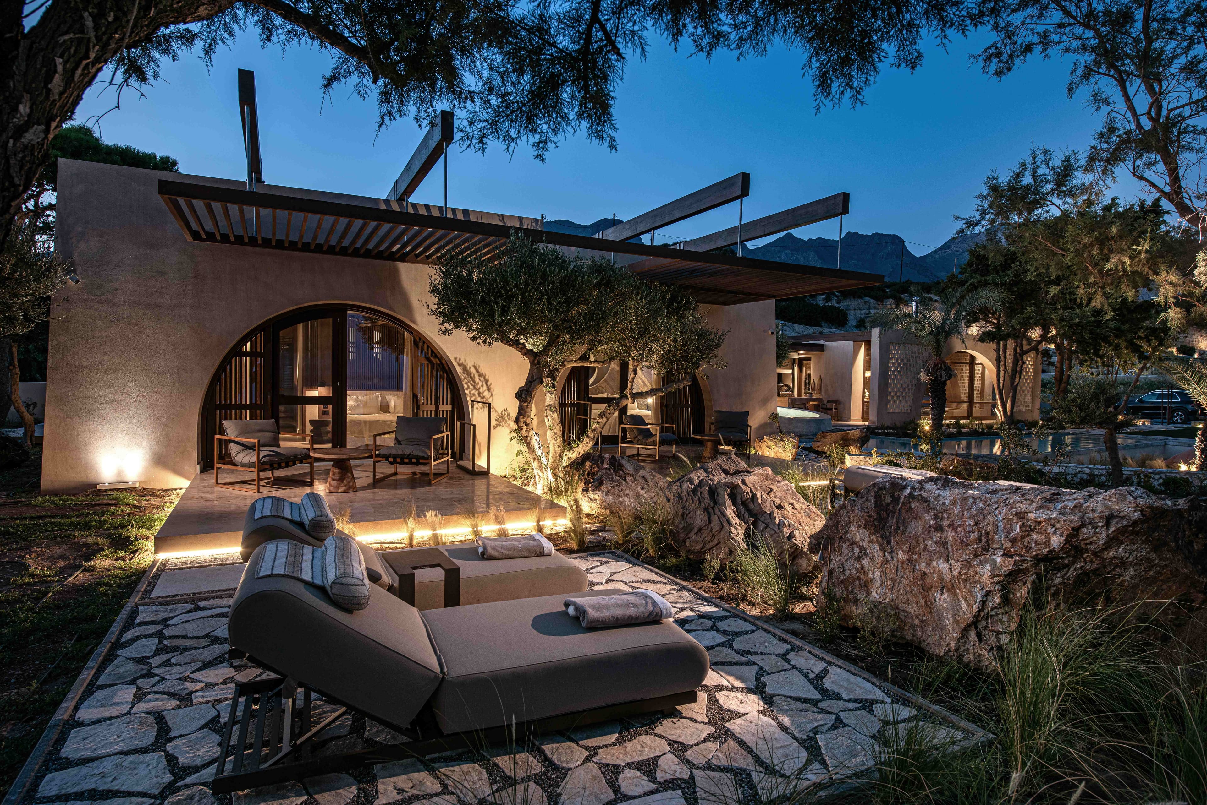 Villa exterior at twilight with lounge furniture and ocean view